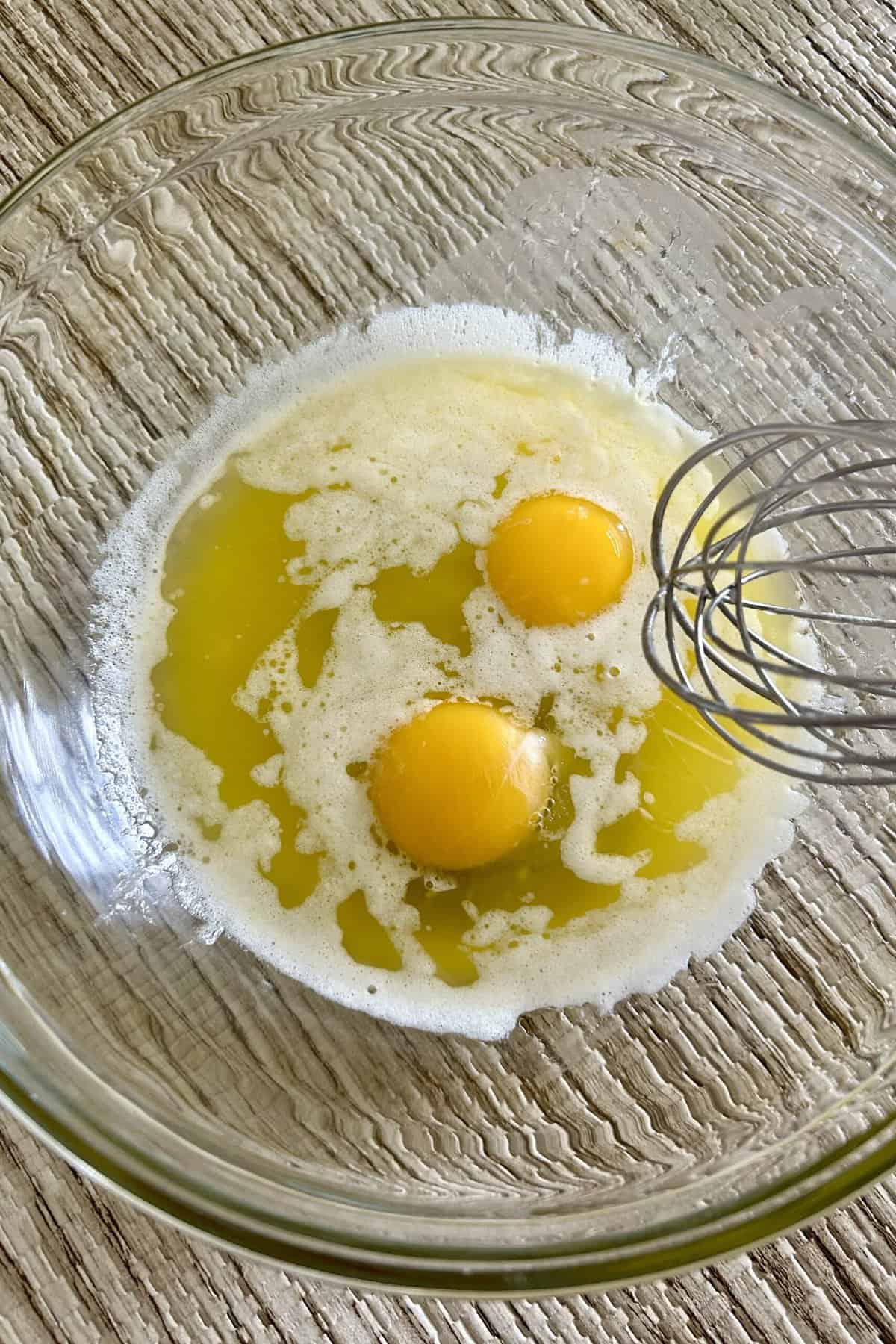 Melt butter in a glass bowl and add two eggs.