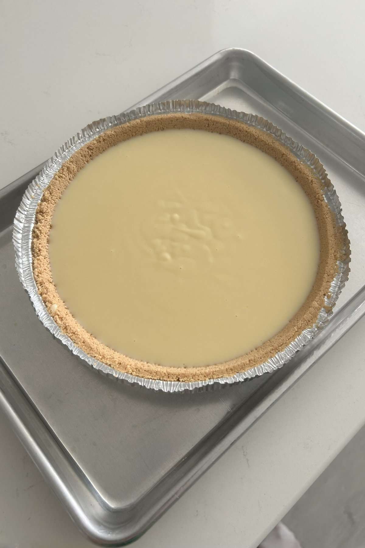 Batter in the graham cracker crust ready to bake