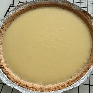 Baked grandma's key lime pie cooling on a wire rack