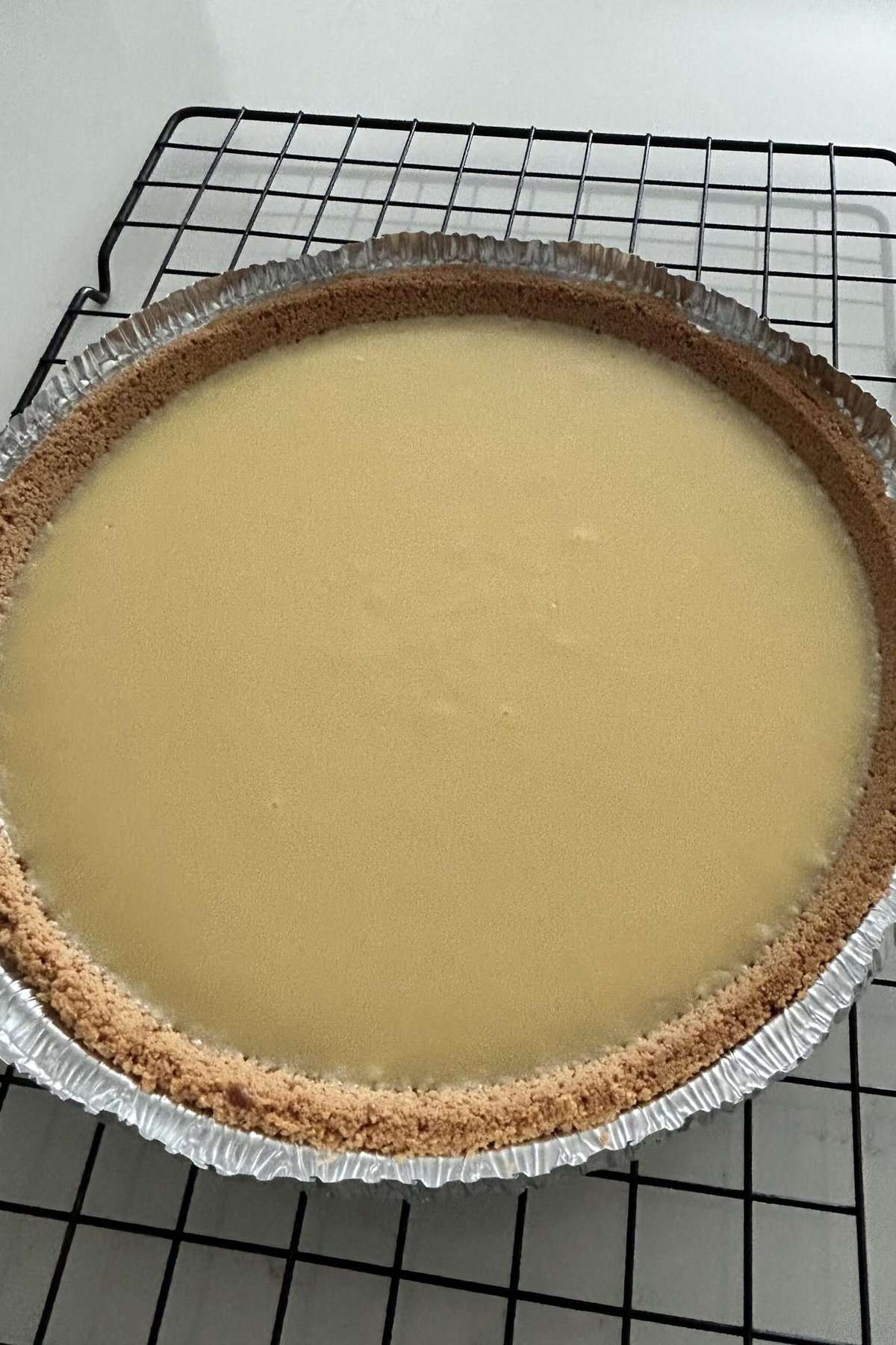 Baked key lime pie on a wire rack to cool off