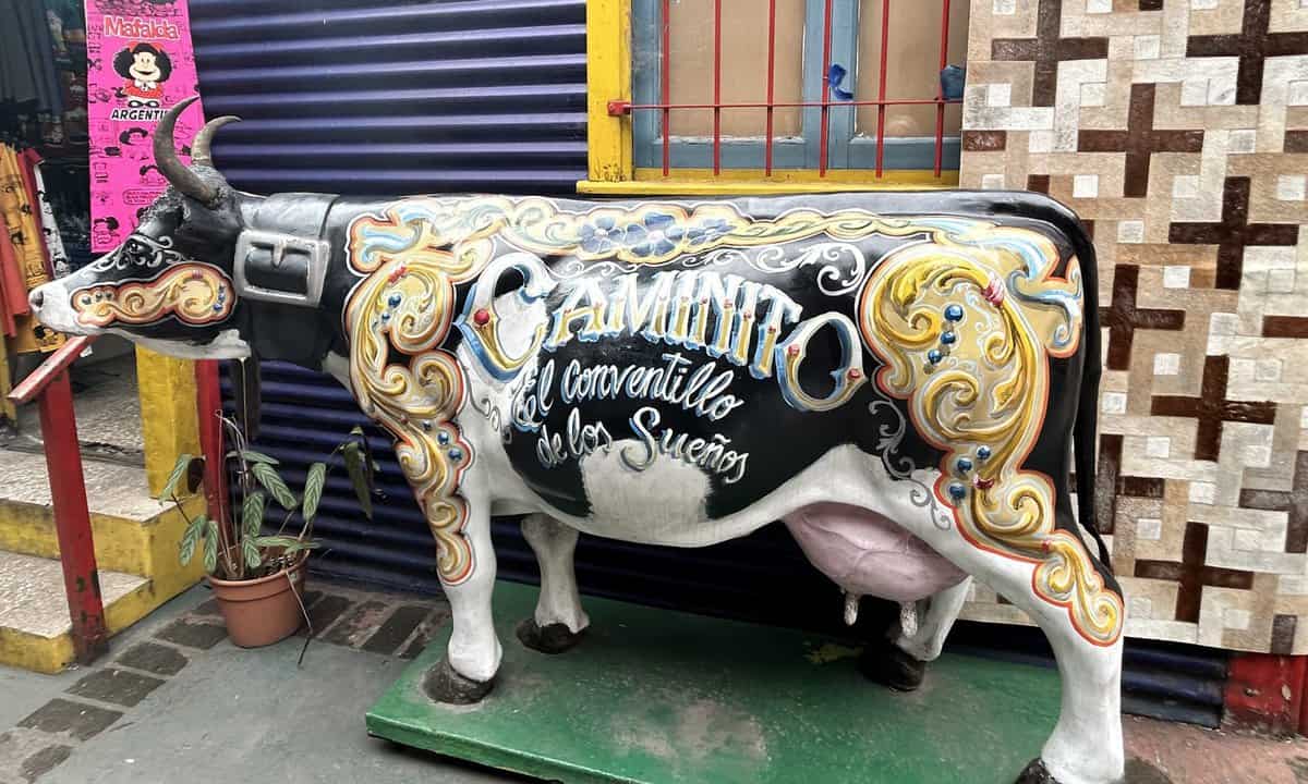 A colorful painted cow with Caminito on it