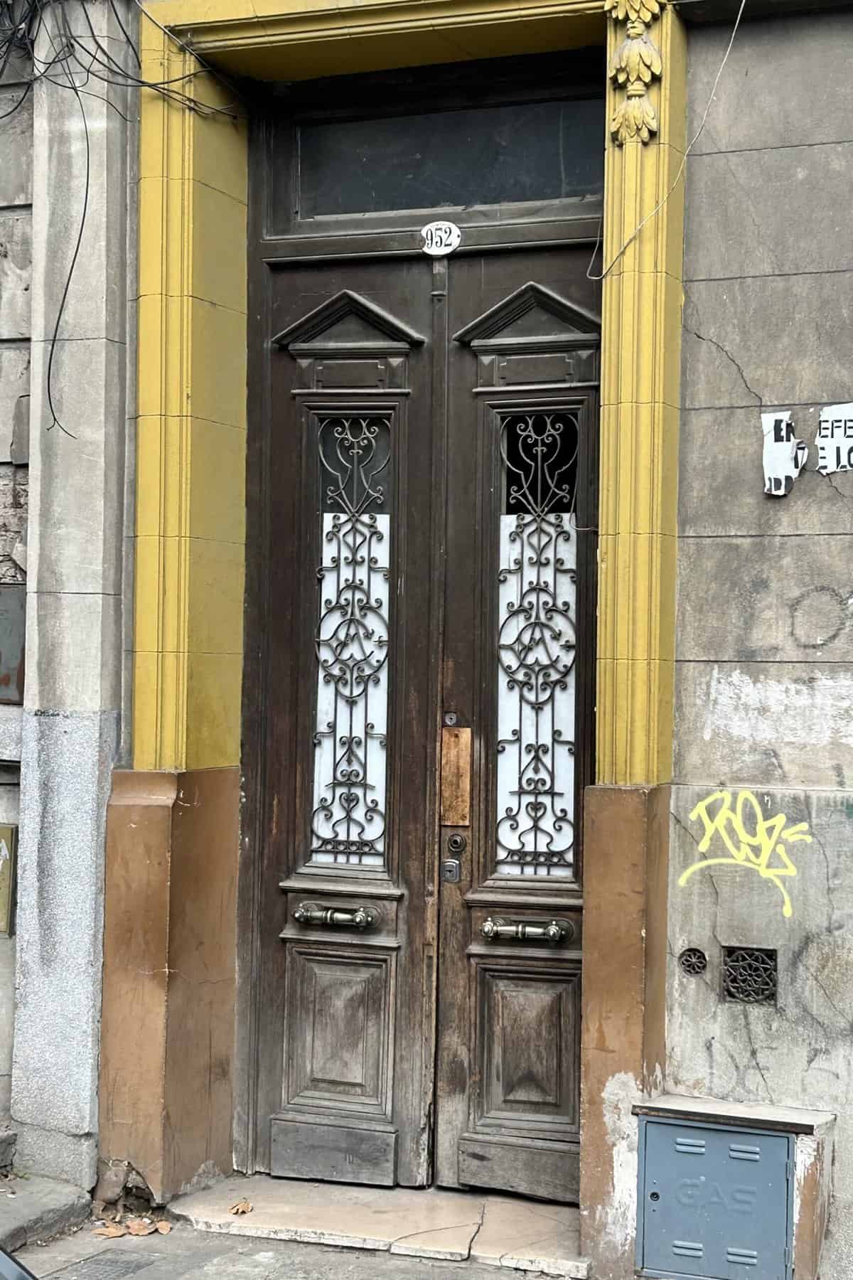 Old brown wooden door with iron works in Caminito