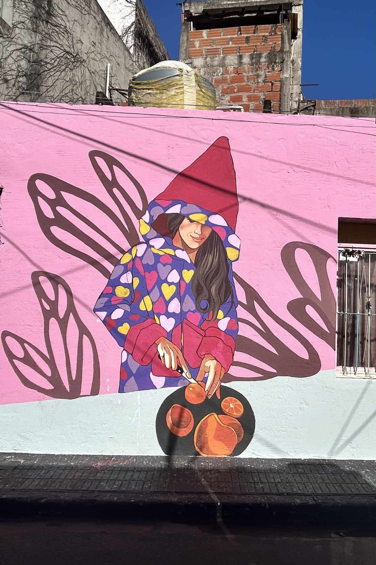 A woman wearing a robe in heart prints is cutting grapefruits