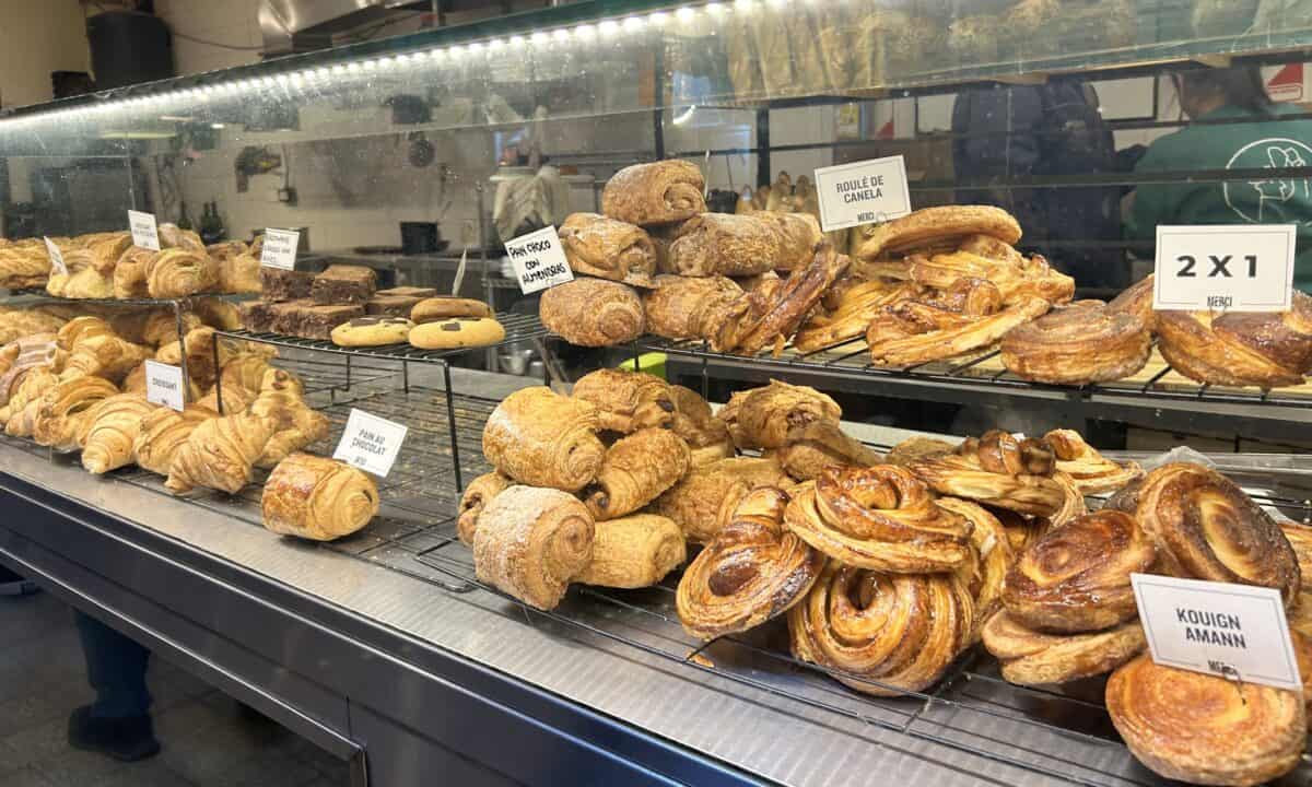 Lots of pastries including roule de canela displayed at a bakery in San Telmo Market