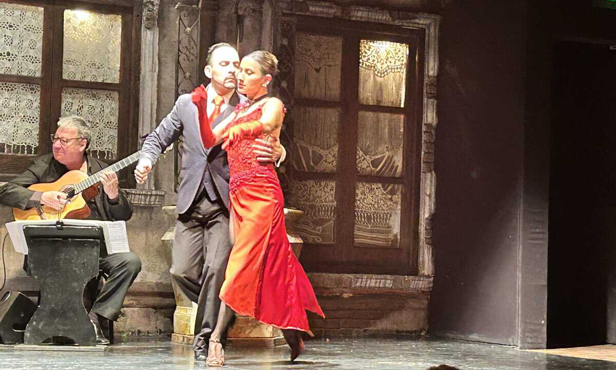 Couple dancing tango. The lady was wearing red dress.