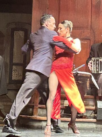 Two tango dancers. The female dancer wore a beautiful red dress.