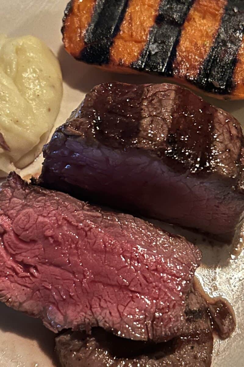 Steak mashed potato and grilled sweet potato on a plate