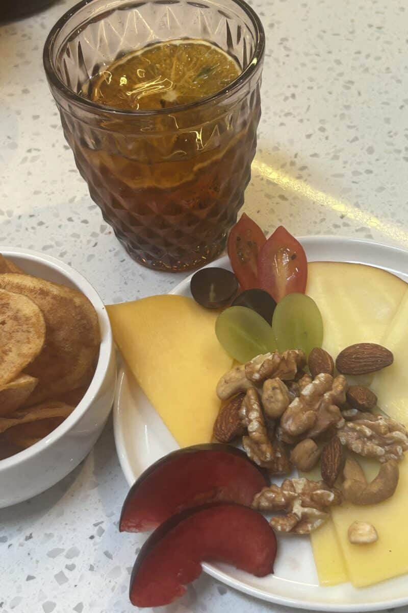 Cheese fruits nuts and drink in the beginning of the cooking class