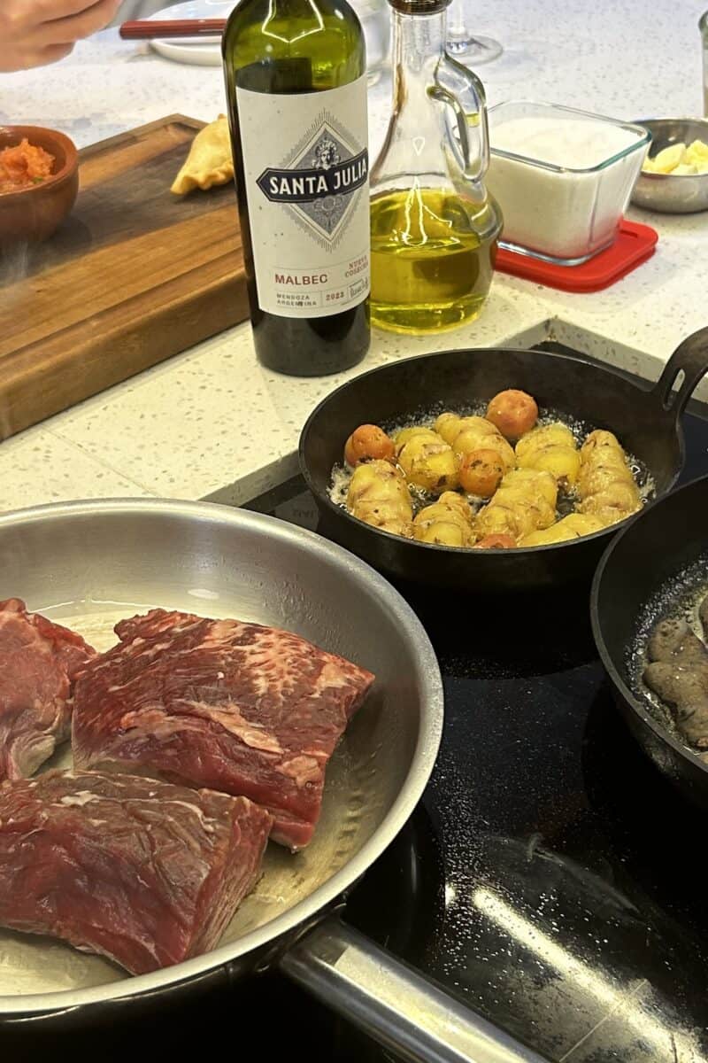 Cooking tenderloin potatoes and carrots on the stove at Criolla cooking school