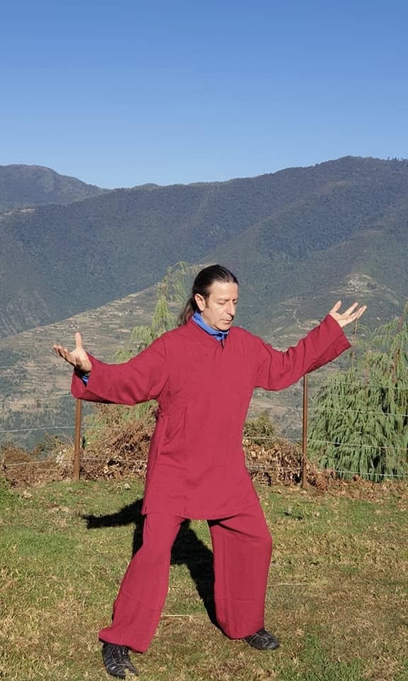 A Chinese martial art master doing Tai Chi at a remote mountain area