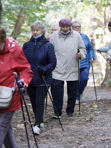 Elderly people holding canes walking in trail