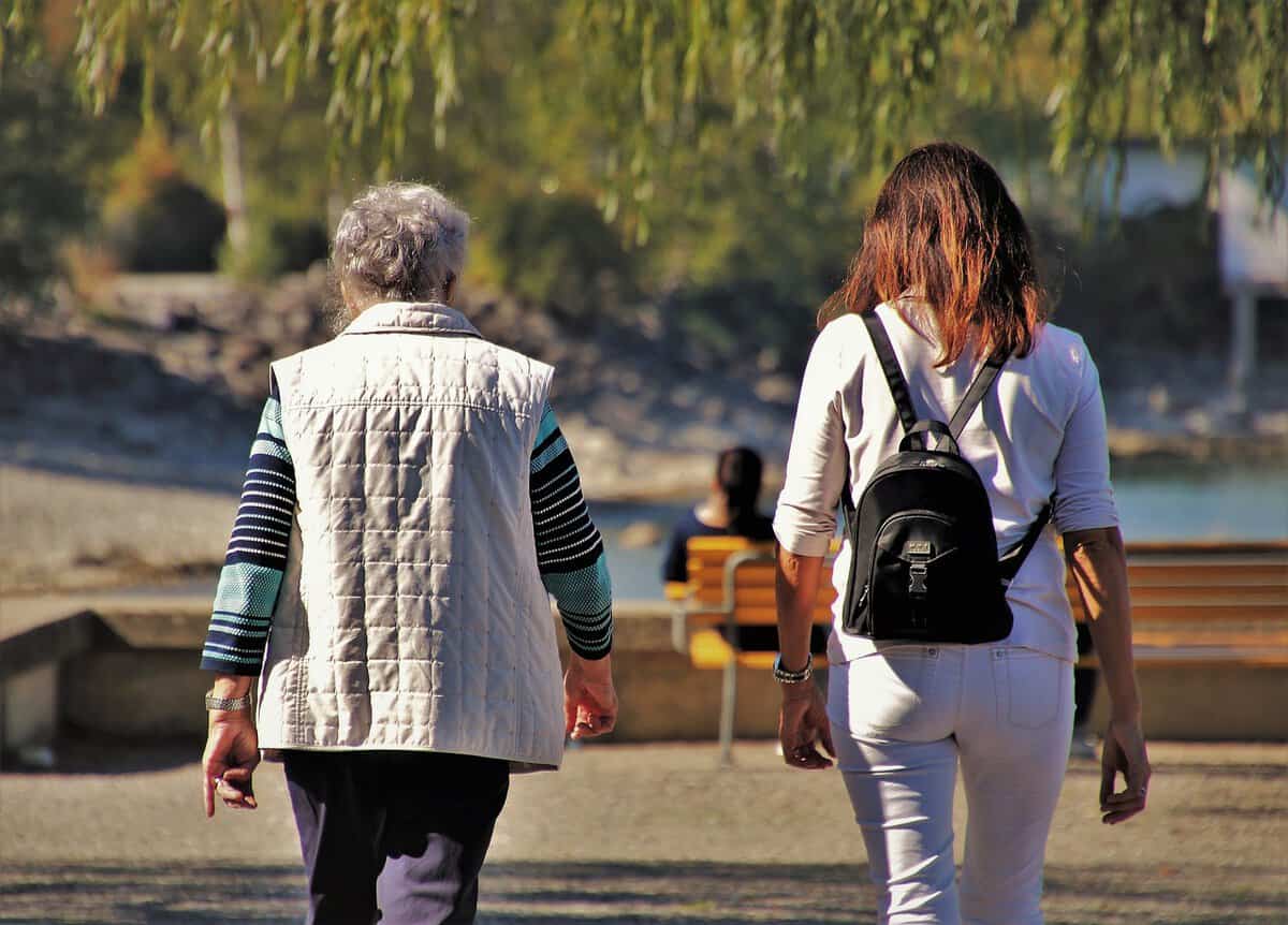 An old lady and a young lady walking 